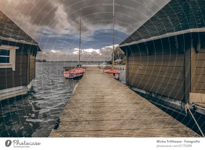 Boathouses and sailboats at the jetty Leisure and hobbies Sailing Vacation & Travel Tourism Waves House (Residential Structure) Nature Landscape Water Sky