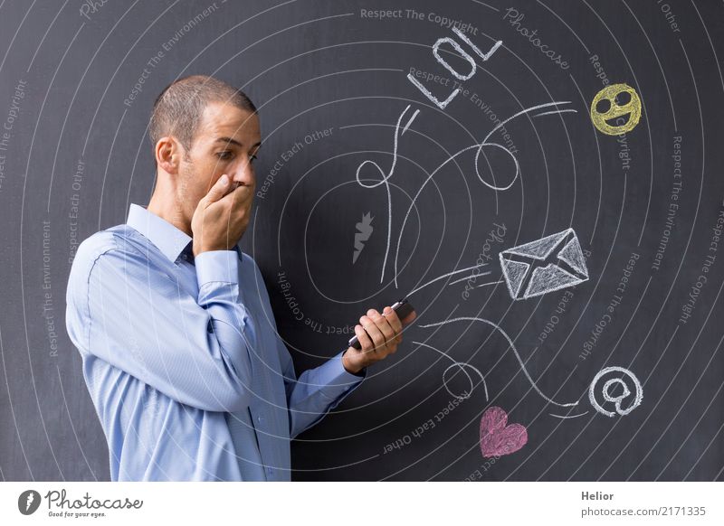 Man with mobile phone in front of chalk-drawn social media symbols on a blackboard (Topic: Social Media Overload) Lifestyle Joy Cellphone PDA Internet Masculine