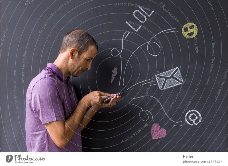 Man with mobile phone in front of chalk-drawn social media symbols on a blackboard (Topic: Social Media Overload) Lifestyle Joy Cellphone PDA Internet