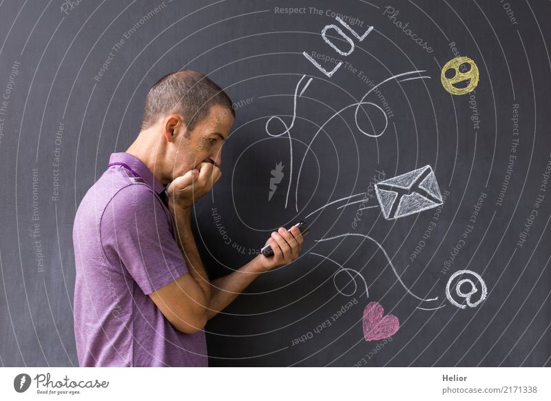 Concept of social media chat. Single white adult man standing in front of a blackboard using his smart phone Lifestyle Cellphone PDA Internet Masculine Man