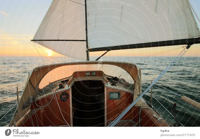 Sailing in calm seas before the wind into the sunrise sunset Sailboat Sailing ship Ocean Adventure Sun Waves Yachting Water Cloudless sky Sunrise Sunset