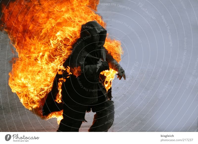 stuntman Stunt Human being 1 Protective clothing Walking Running Speed Yellow Gray Red Black Fear Horror Fear of death Threat Blaze Flame Colour photo