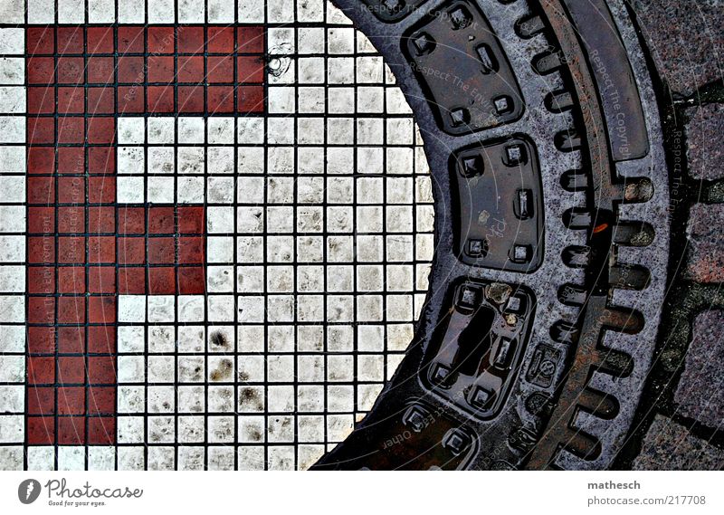f Street Stone Metal Water Sign Characters Red White Gully Cap Rain Wet Colour photo Exterior shot Deserted Day Contrast Bird's-eye view Mosaic Tile