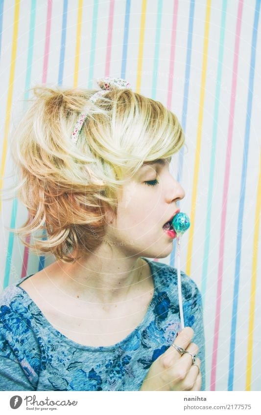 Young blonde woman biting a lollipop Food Candy Lollipop Human being Feminine Young woman Youth (Young adults) 1 18 - 30 years Adults Hairband