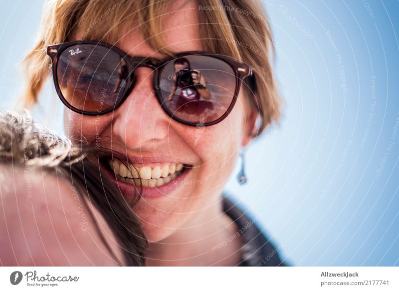 Woman with sunglasses laughing happily 2 people Day Young woman Happy Joy Contentment Love Sunglasses Head Portrait photograph Laughter Smiling Cloudless sky