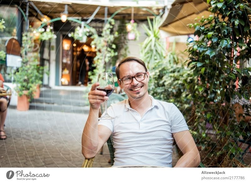 Man with wine glass sits in the chair and is happy 1 Person Young man Sit Day Exterior shot Warmth Summer Wine Wine glass Red wine Alcoholic drinks Drinking