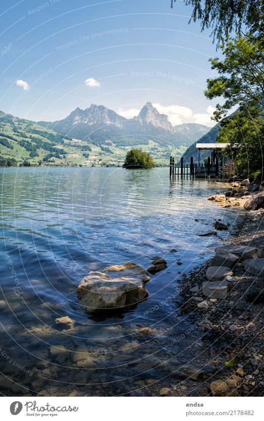 Boardwalk and rocks by the lake with mountains in the background Rock wooden walkway Lake bank Peak Water Sunlight Landscape Nature tranquillity Idyll Calm Sky