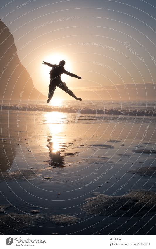 Young woman jumps into the sunset at the Polar Sea Joy Healthy Athletic Fitness Life Well-being Contentment Vacation & Travel Trip Adventure Far-off places