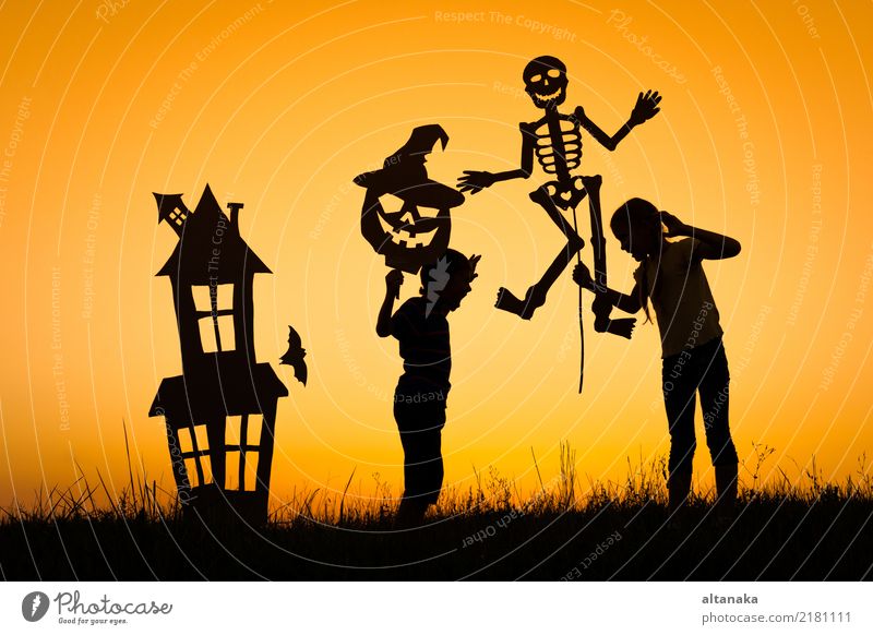 Happy brother and sister playing outdoors Lifestyle Joy Playing House (Residential Structure) Feasts & Celebrations Hallowe'en Child Human being Boy (child)