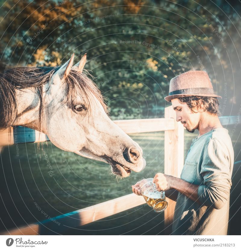Beer for horses Lifestyle Human being Young man Youth (Young adults) Hand Nature Animal Horse Emotions Moody Joy Oktoberfest Humor Funny Colour photo