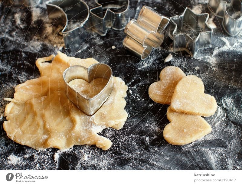Close up of cookie cutters in a dough on a dark table Dough Baked goods Dessert Kitchen Heart Make Baking Bakery biscuit cooking Cutter Knife Flour food