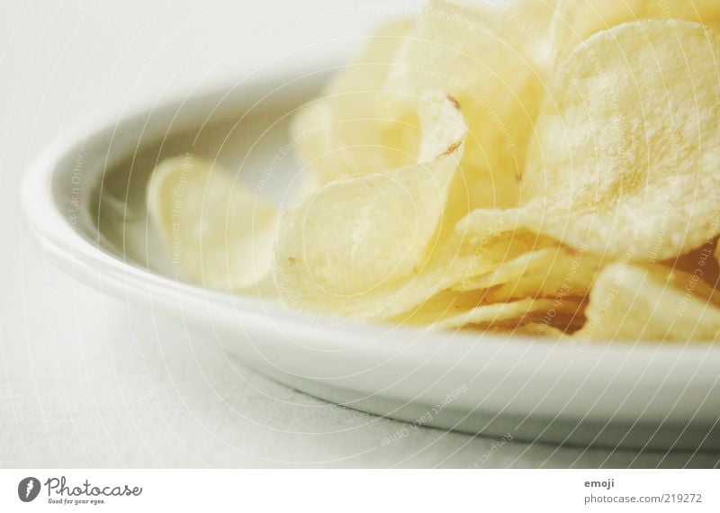 CHCHKZKKCHCH Nutrition Fast food Finger food Plate Yellow White Crisps Salty Fat Unhealthy Colour photo Neutral Background Shallow depth of field Detail