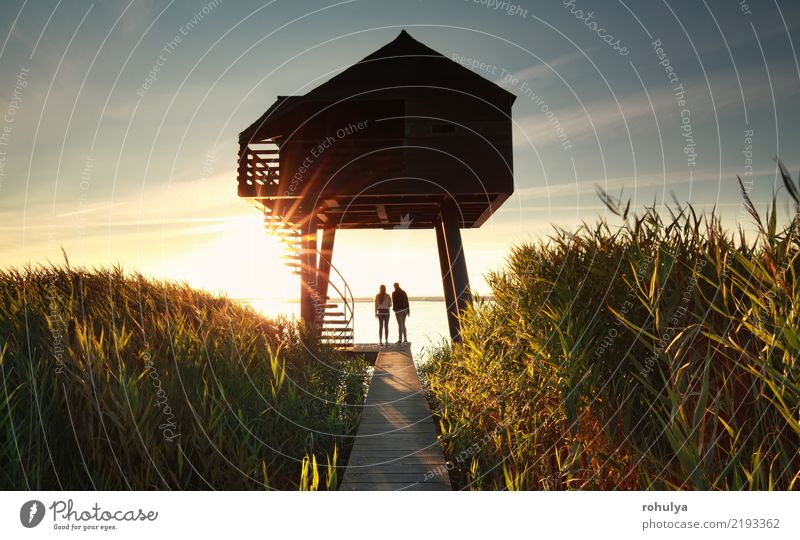 couple by wooden observing tower at sunset Summer Sun Ocean Couple Landscape Sky Coast Lake Building Architecture Lanes & trails Together Serene Relationship