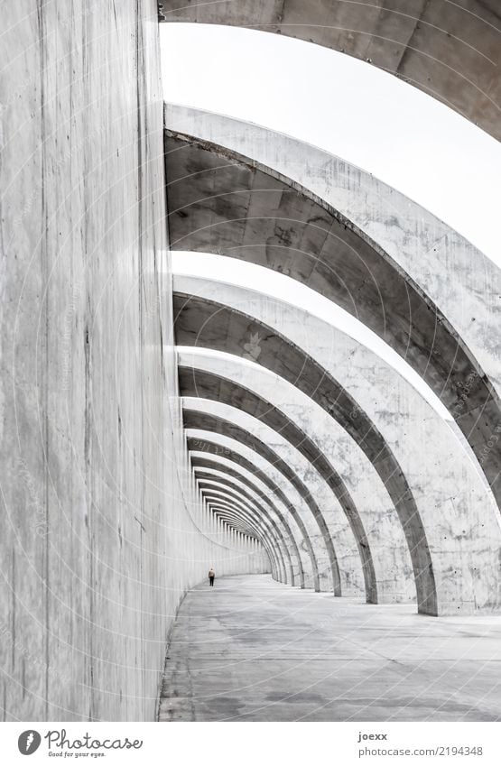 Modern exposed concrete structure, wall with arches and walkers harbour wall Protection Breakwater dam Architecture Manmade structures Breakwaters Concrete