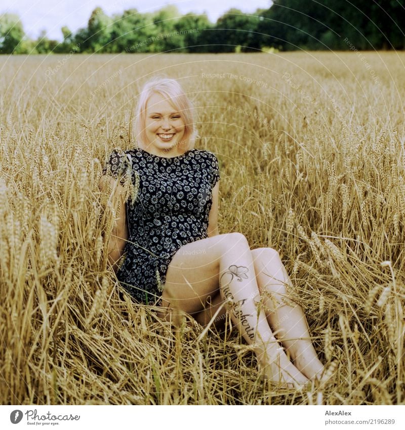 analogue portrait of a young woman sitting barefoot in a rye field in a summer dress and smiling already Life Well-being Young woman Youth (Young adults) Legs