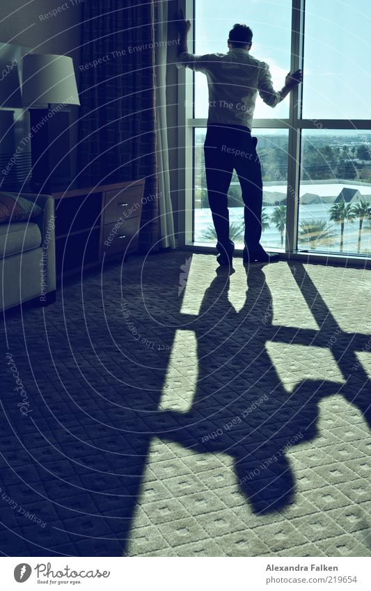 Man at window VI Human being Masculine Adults Life 1 Wait Esthetic Cool (slang) Reliability Luxury Sunlight Carpet Window Hotel room Business trip Colour photo