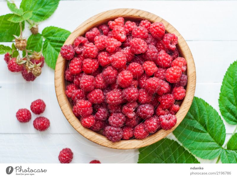 ripe red raspberries Fruit Nutrition Bowl Summer Wood Eating Fresh Natural Above Red White Raspberry background Berries Top Vantage point sweet food close up