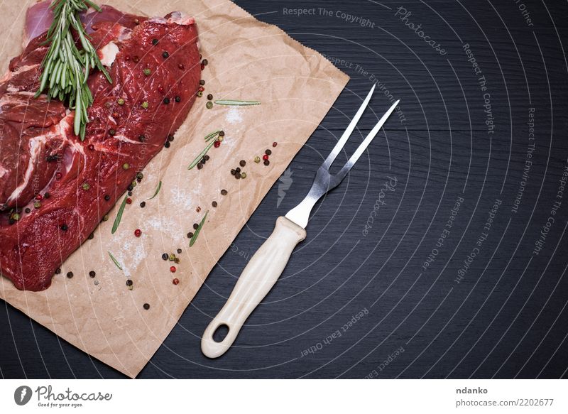 piece of raw beef Meat Herbs and spices Dinner Fork Table Kitchen Paper Wood Eating Fresh Green Red Black Meal pepper Beef Chop Organic salt Gourmet Raw