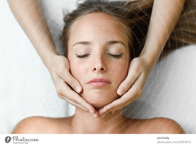 Young blond woman receiving a head massage in a spa center Lifestyle Happy Beautiful Skin Face Health care Medical treatment Wellness Relaxation Spa Massage