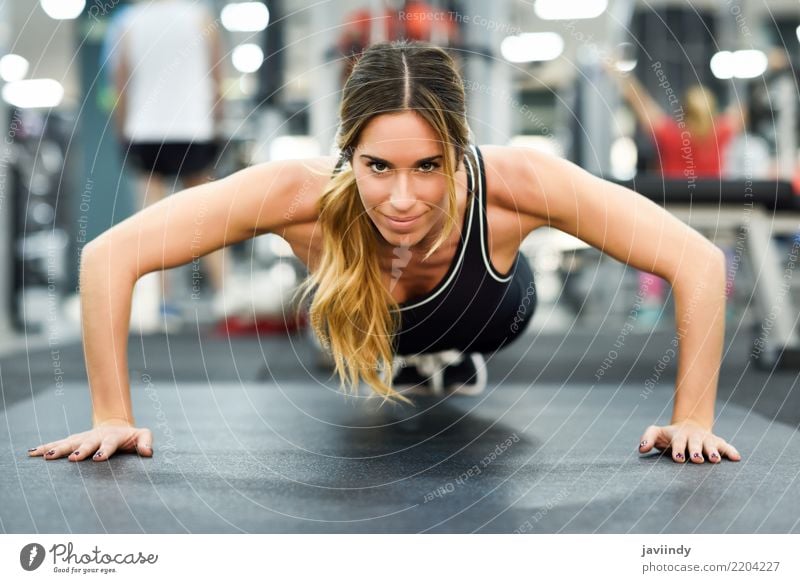 Young beautiful woman doing pushups in the gym. Lifestyle Body Sports Fitness Sports Training Human being Woman Adults 1 18 - 30 years Youth (Young adults)