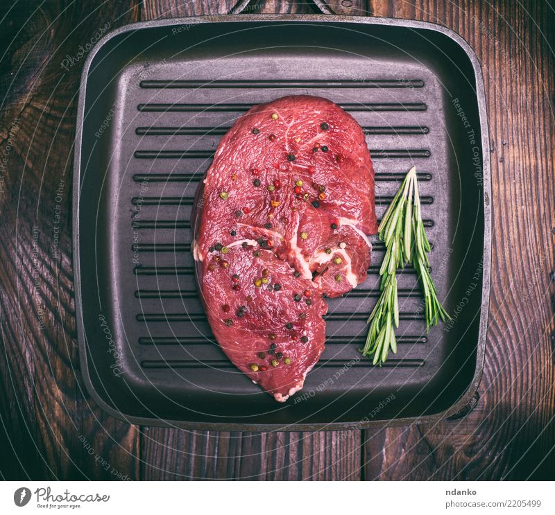 raw beef on a black frying pan Meat Herbs and spices Dinner Pan Table Kitchen Wood Eating Fresh Above Red Black Meal barbecue Beef Chop Organic grill Gourmet