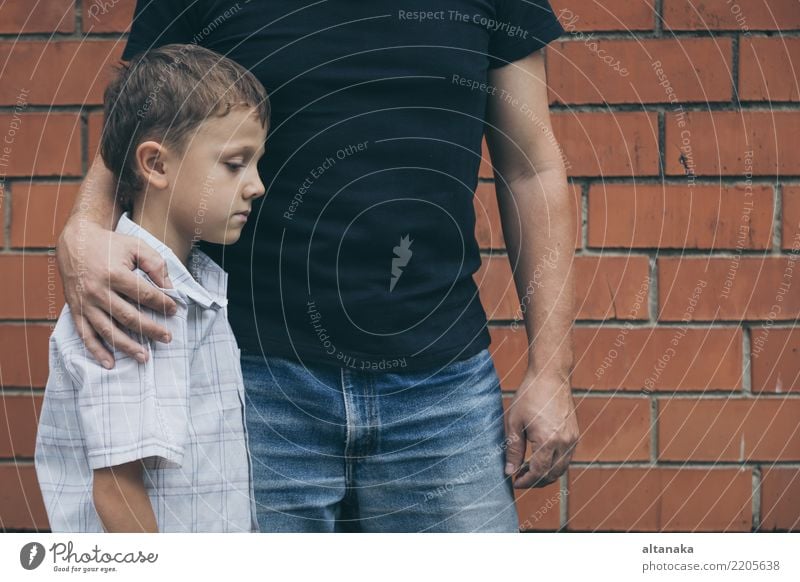 Portrait of young sad little boy and father sitting outdoors at the day time. Concept of sorrow. Face Child Boy (child) Man Adults Parents Father