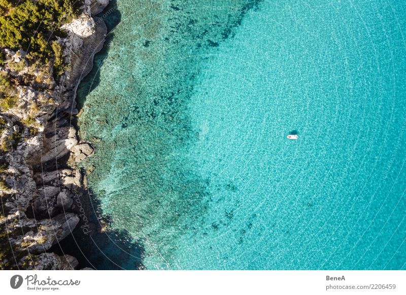 Boat anchors in rocky bay with turquoise blue sea from above Relaxation Swimming & Bathing Vacation & Travel Tourism Trip Adventure Far-off places Freedom