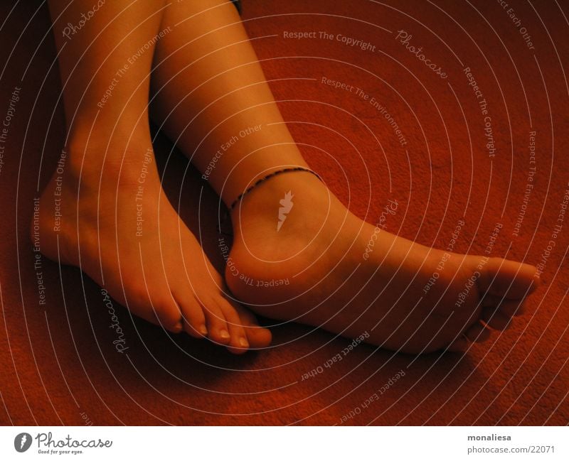 feet1 Feminine Toes Carpet Ankle chain Woman Legs Feet Orange Pedicure Women`s feet Barefoot Neutral Background Lie Sole of the foot