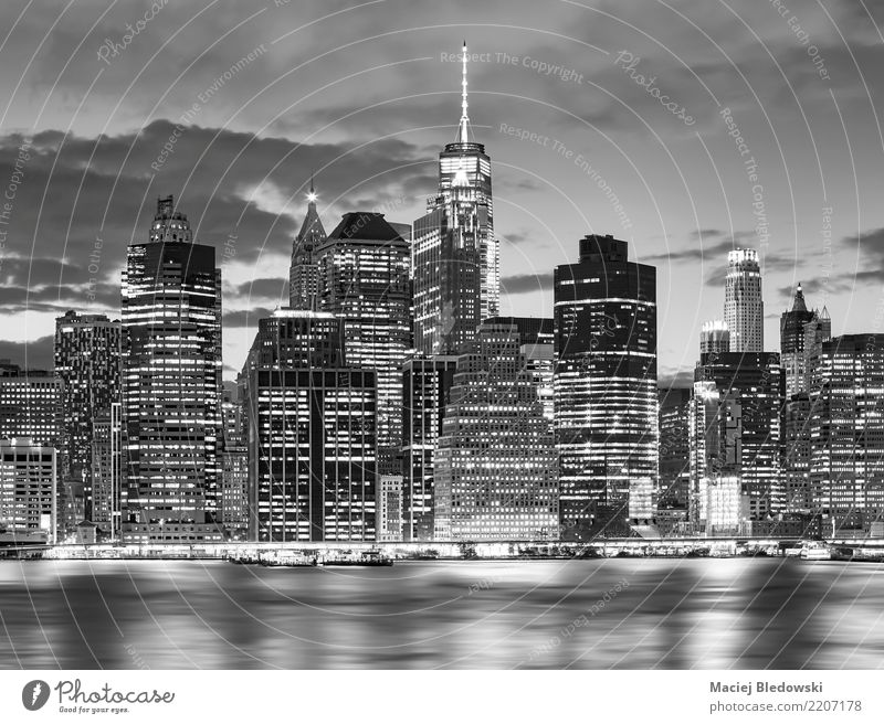 Black and white picture of New York City skyline at nigh. Workplace Office River Town Downtown Skyline High-rise Bank building Building Architecture Landmark