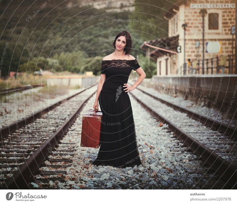 Young woman on train tracks - a Royalty Free Stock Photo from Photocase