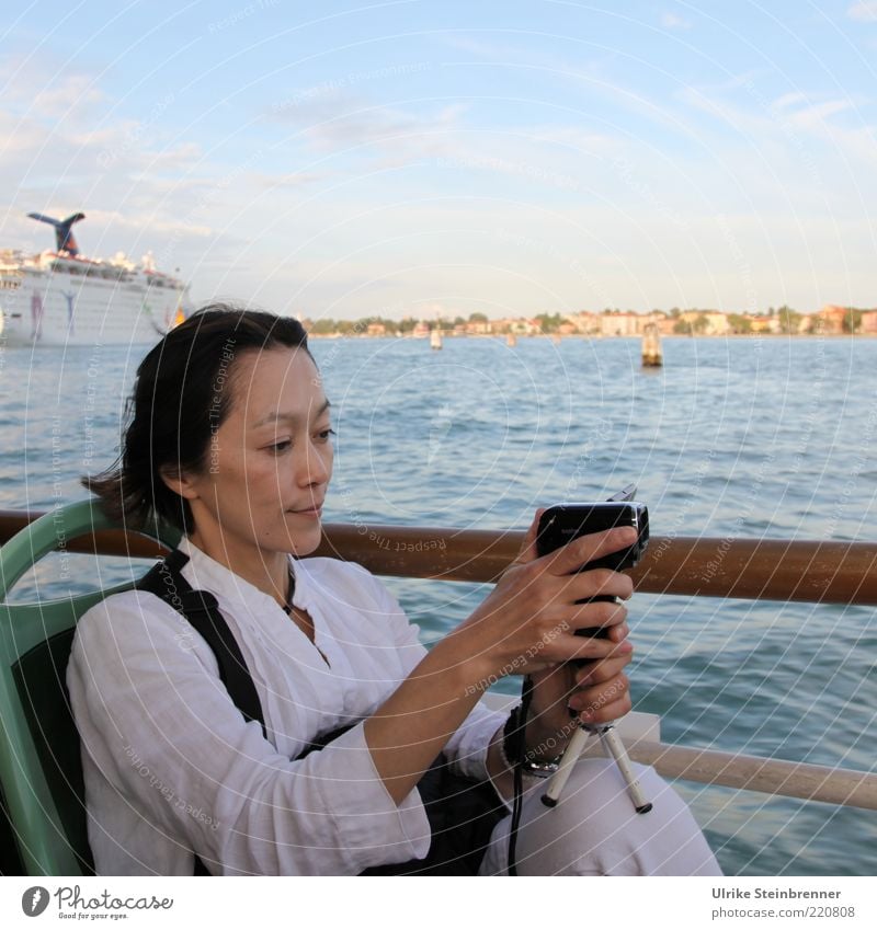 Japanese woman filming in Venice Bay Joy Vacation & Travel Tourism Trip Sightseeing City trip Video camera Human being Feminine Woman Adults 1 Media Water coast