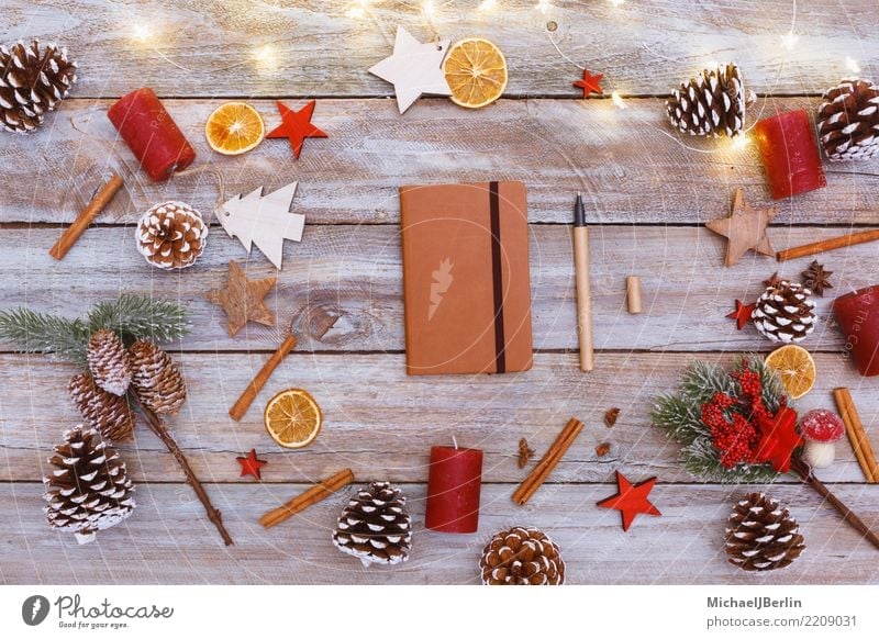 Table with Christmas decoration and notebook Winter Christmas & Advent Write Chaos Arranged Reindeer Notebook Pen December Light Decoration Fir cone Wood Paper