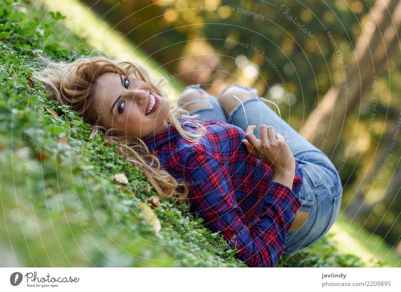 Young woman with long blond curly hair laying on grass Lifestyle Joy Happy Beautiful Hair and hairstyles Relaxation Human being Feminine Youth (Young adults)