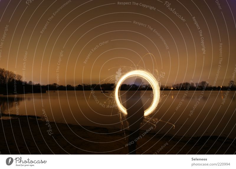 Ring of Fire Human being Environment Nature Landscape Water Sky Night sky Horizon Plant Coast Lakeside River bank Beach Rotate Glittering Illuminate Draw