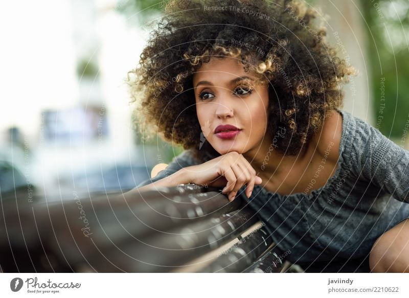 Young black woman with afro hairstyle sitting on a bench in urban background. Lifestyle Style Happy Beautiful Hair and hairstyles Face Human being Woman Adults