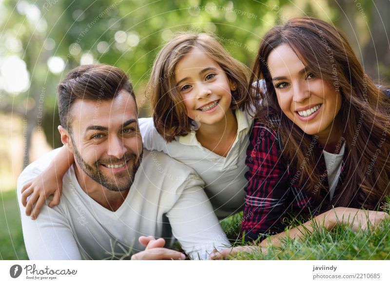 Happy young family in a urban park. Lifestyle Joy Beautiful Summer Child Woman Adults Man Parents Mother Father Family & Relations Infancy Group Nature Autumn