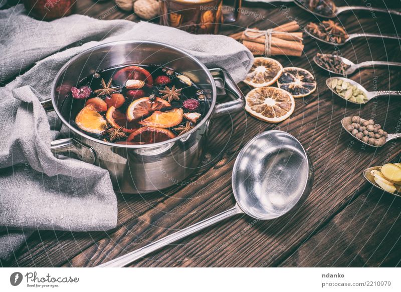 hot mulled wine in a pot with handles Apple Orange Herbs and spices Beverage Alcoholic drinks Wine Pan Spoon Winter Table Feasts & Celebrations