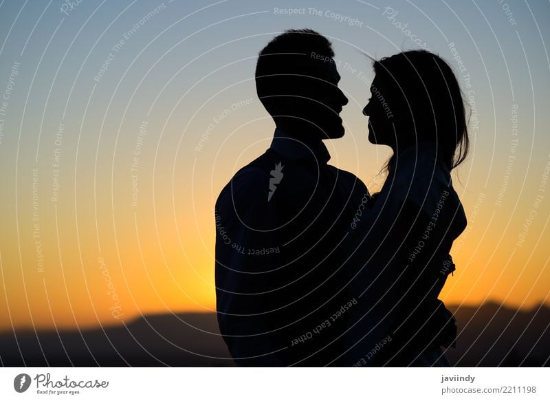 Silhouette of a young bride and groom on Sunset background Happy Beautiful Wedding Human being Woman Adults Man Couple 2 18 - 30 years Youth (Young adults) Sky