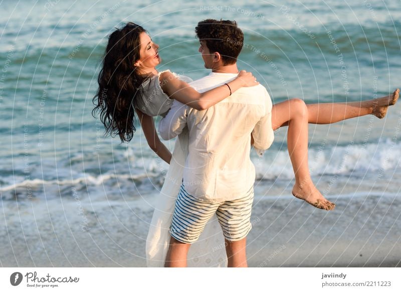 Young happy couple walking in a beautiful beach. Lifestyle Joy Happy Beautiful Hair and hairstyles Vacation & Travel Summer Beach Ocean Human being Masculine