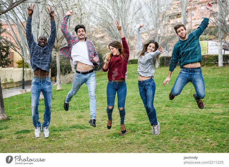 Group of multi-ethnic young people jumping together outdoors Lifestyle Joy Human being Young woman Youth (Young adults) Young man Woman Adults Man Friendship 5