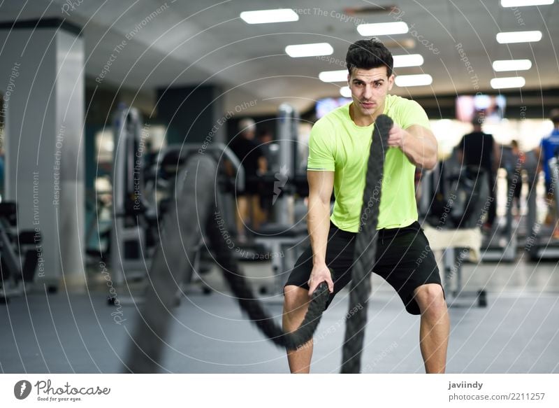 Man with battle ropes exercise in the fitness gym. Joy Beautiful Body Waves Club Disco Sports Climbing Mountaineering Human being Masculine Adults Friendship 1