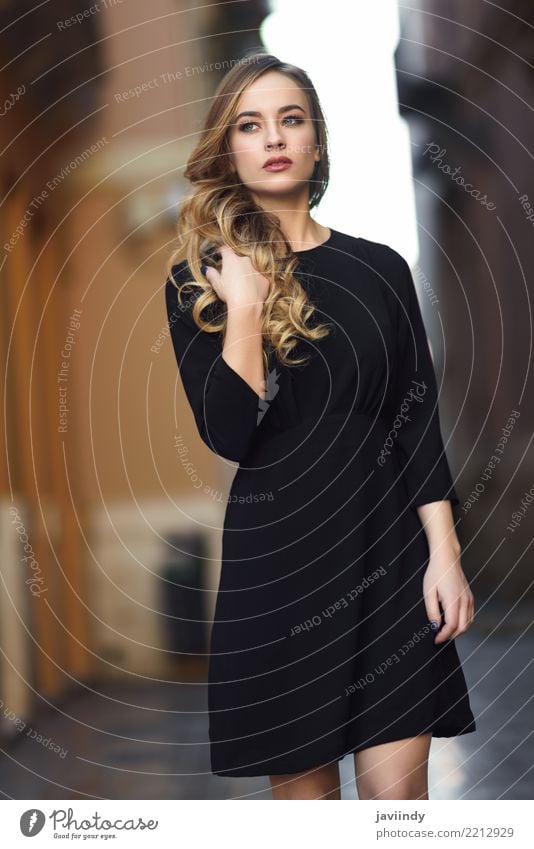 Blonde woman in urban background wearing black dress Lifestyle Style Beautiful Hair and hairstyles Face Human being Feminine Woman Adults 1 18 - 30 years