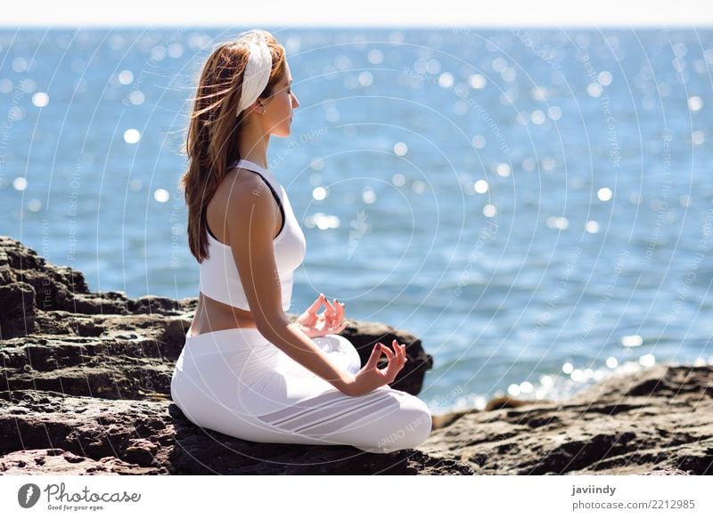 Young woman doing yoga in the beach. Lifestyle Beautiful Wellness Relaxation Meditation Summer Beach Ocean Sports Yoga Human being Feminine Woman Adults Body 1