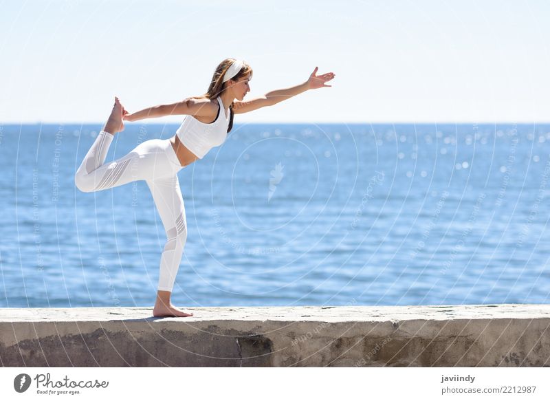 Young woman doing yoga in the beach. Lifestyle Beautiful Wellness Relaxation Meditation Summer Beach Ocean Sports Yoga Human being Feminine Woman Adults 1