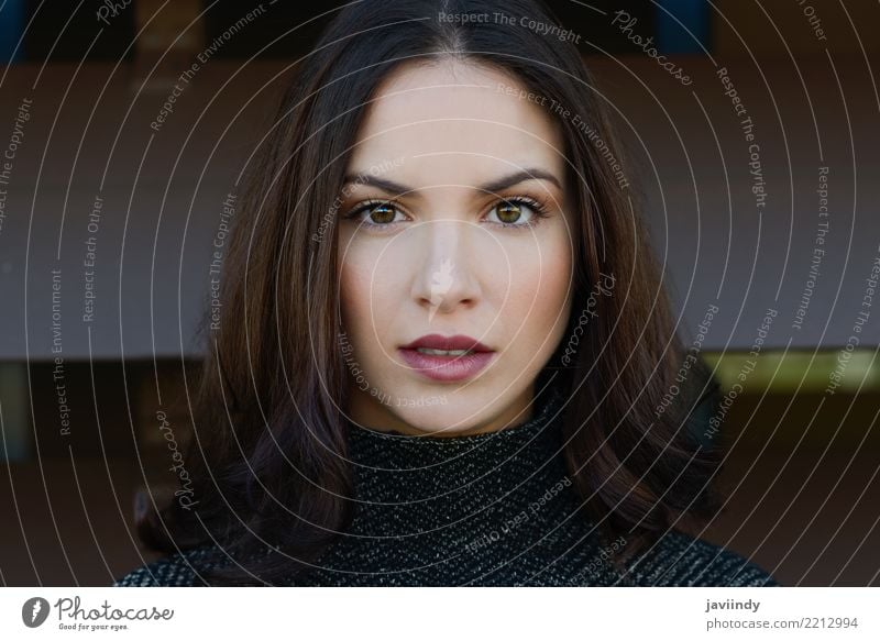 Portrait of attractive fashionable dark-haired woman in white