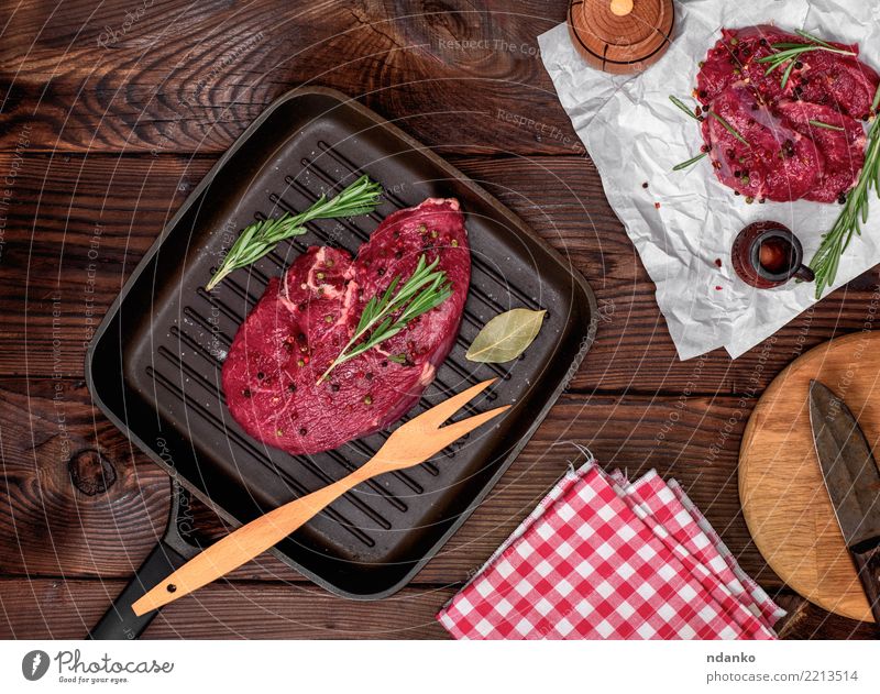 fresh beef steak with rosemary Meat Herbs and spices Dinner Fork Table Paper Wood Fresh Green Red Beef Blood Chop Cut Gourmet Ingredients Loin Meal napkin