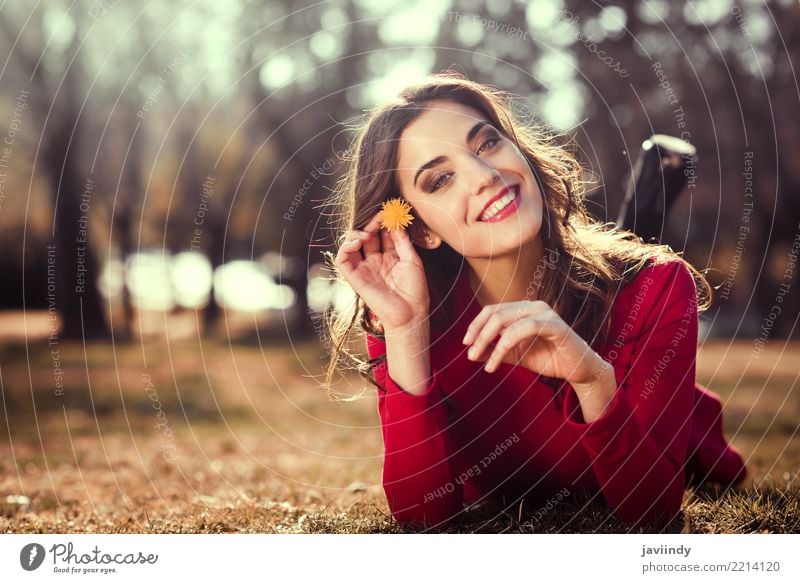 Woman rest in the park with a dandelion in her hair Lifestyle Style Happy Beautiful Hair and hairstyles Face Relaxation Summer Human being Adults Nature Flower