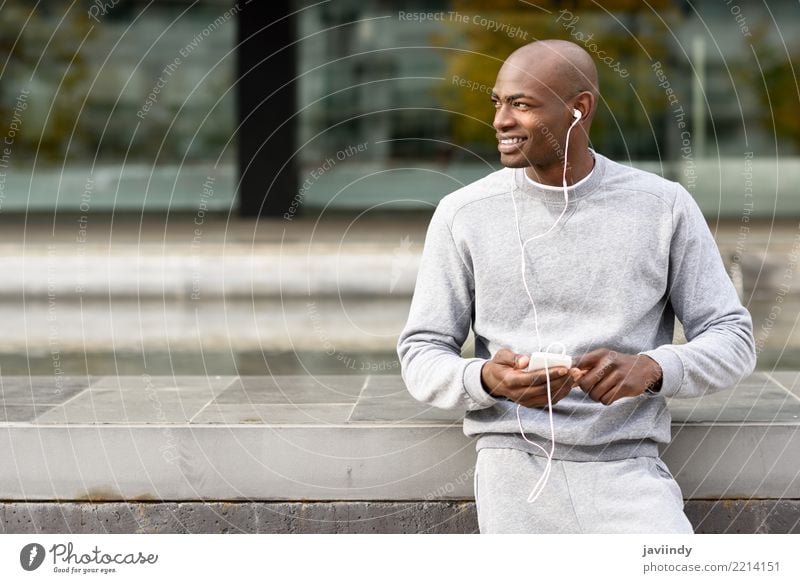 Attractive black man listening to music with headphones Lifestyle Happy Music Sports Telephone PDA Technology Human being Man Adults 1 18 - 30 years