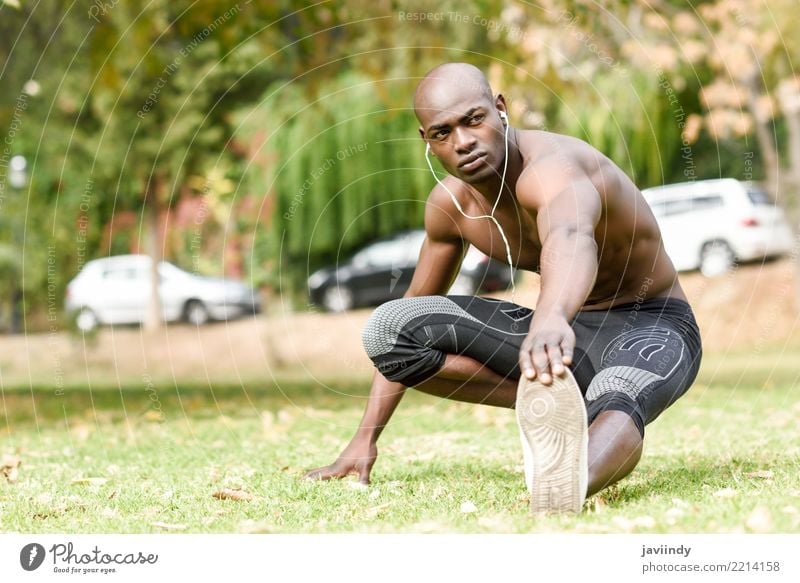 Young black man doing stretching after running in urban park. Lifestyle Body Sports Human being Masculine Man Adults 1 18 - 30 years Youth (Young adults)
