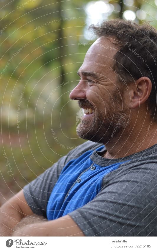 dark-haired middle-aged man stands relaxed and smiling with crossed arms in a park Leisure and hobbies Trip Human being Masculine Man Adults 1 45 - 60 years